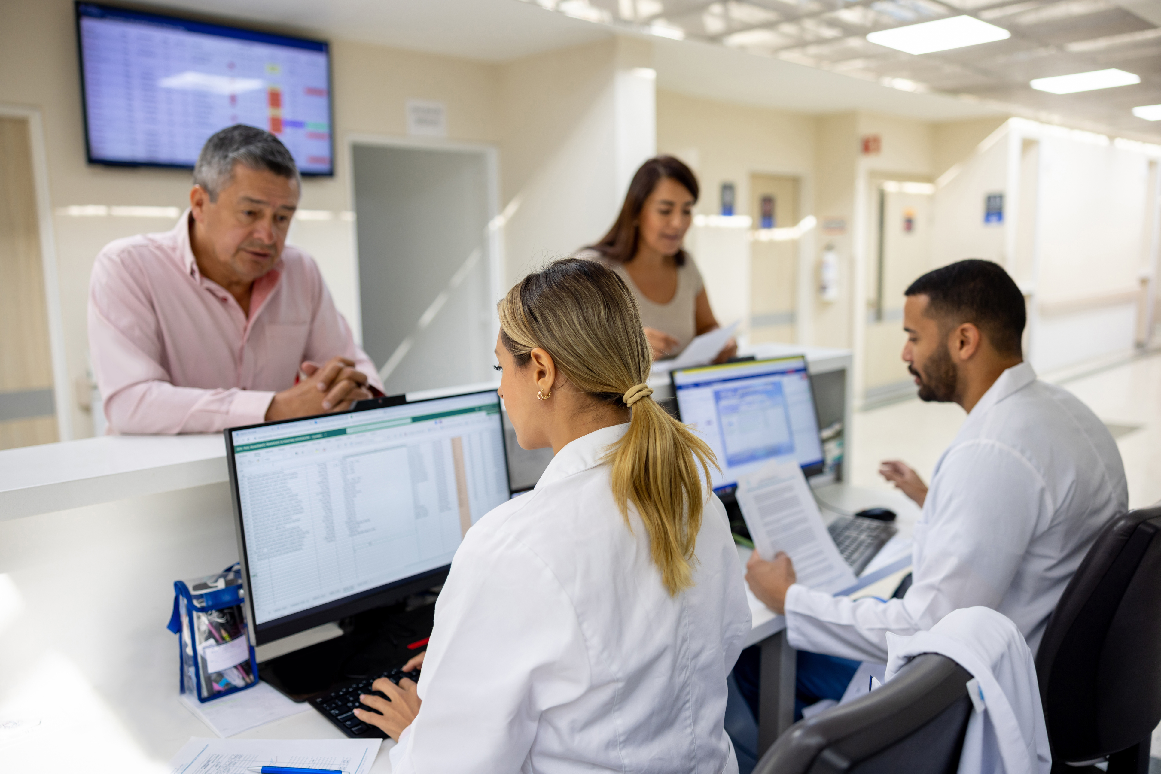 two medical assistants checking in patients