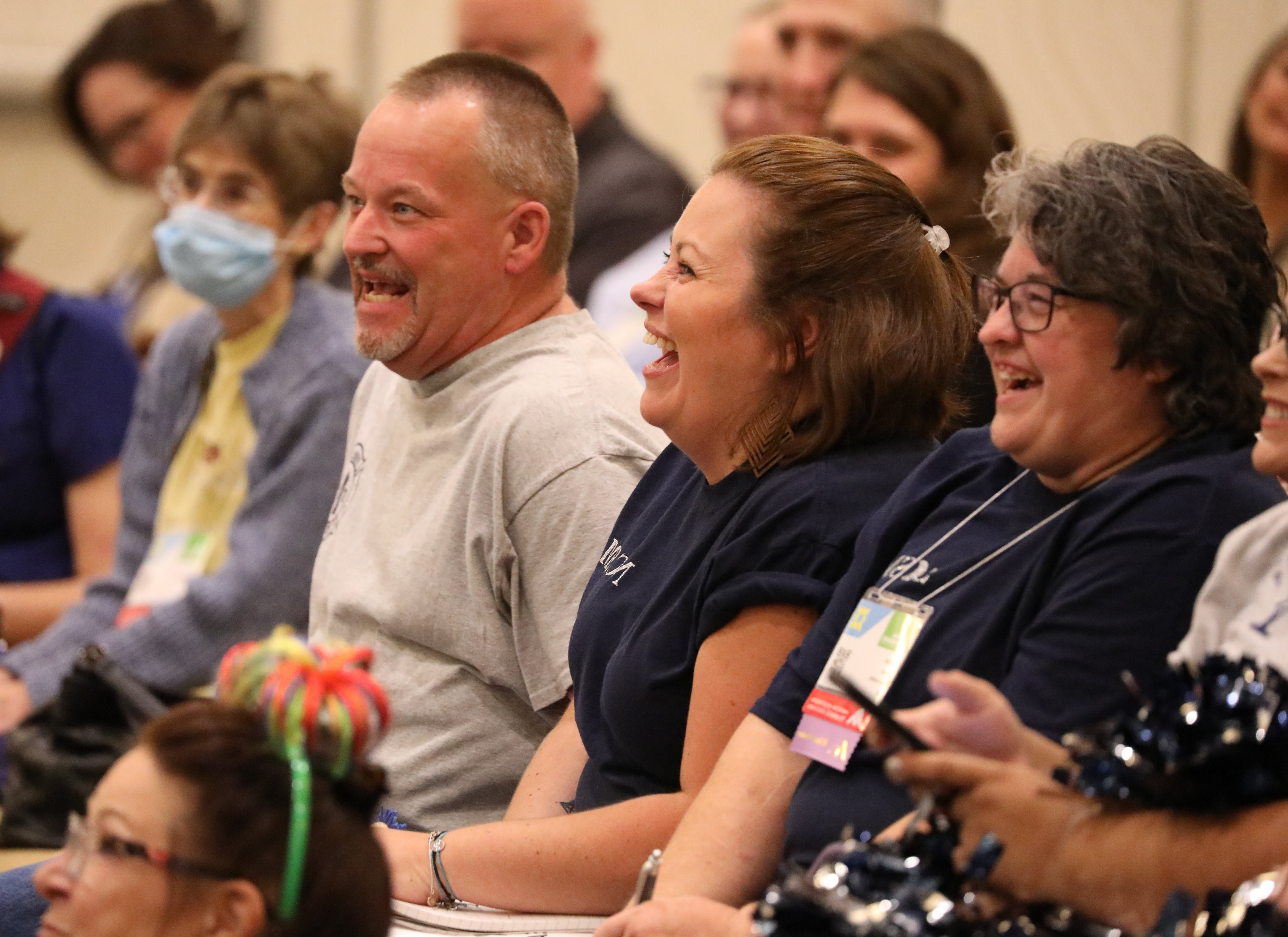 Seated man and women laughing during the 2024 AAMA Conference