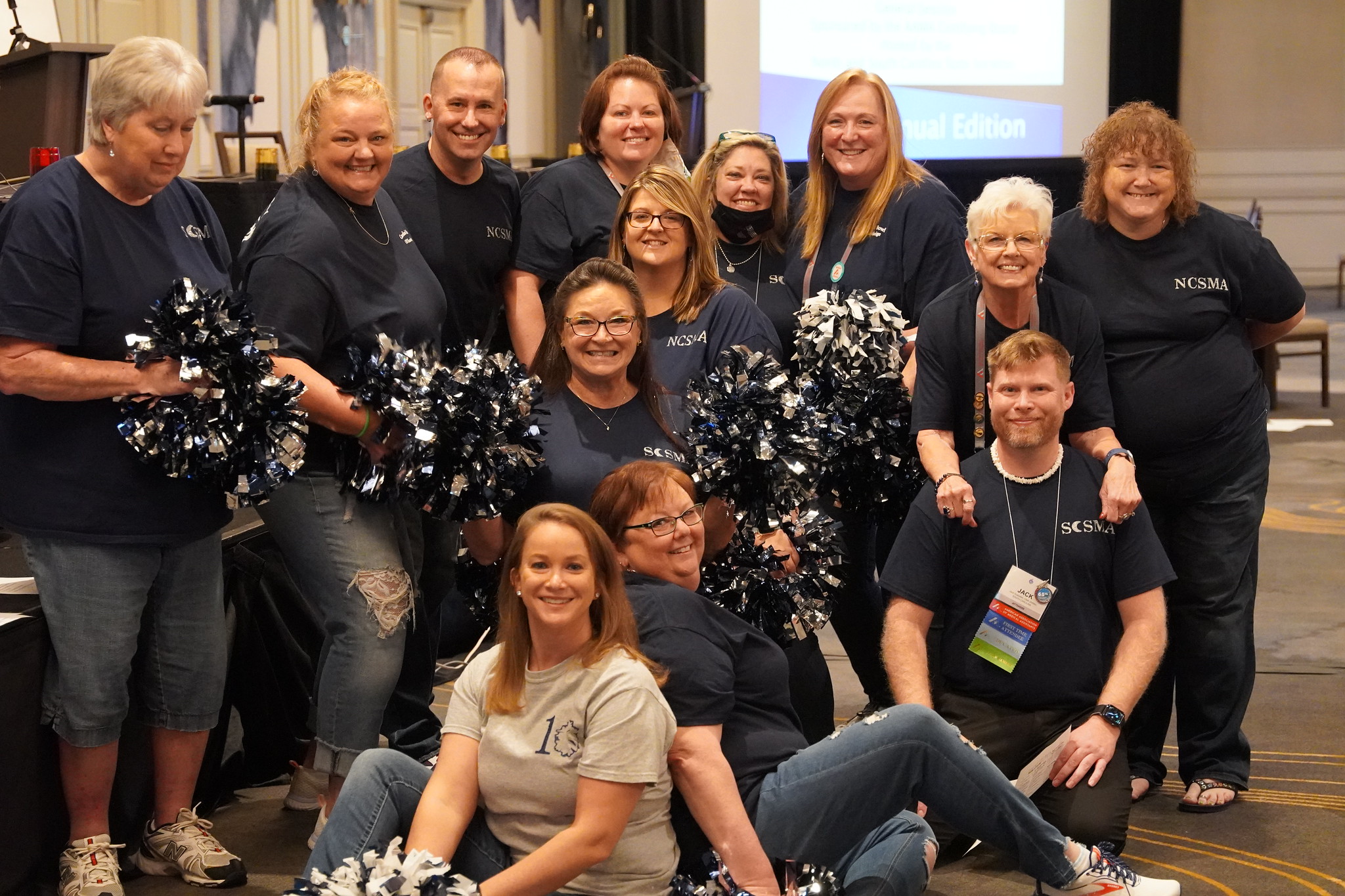 51884003683_28b8c584d7_k A group of NCSMA members wearing matching shirts, cheerleading the CMA (AAMA) Knowledge Bowl
