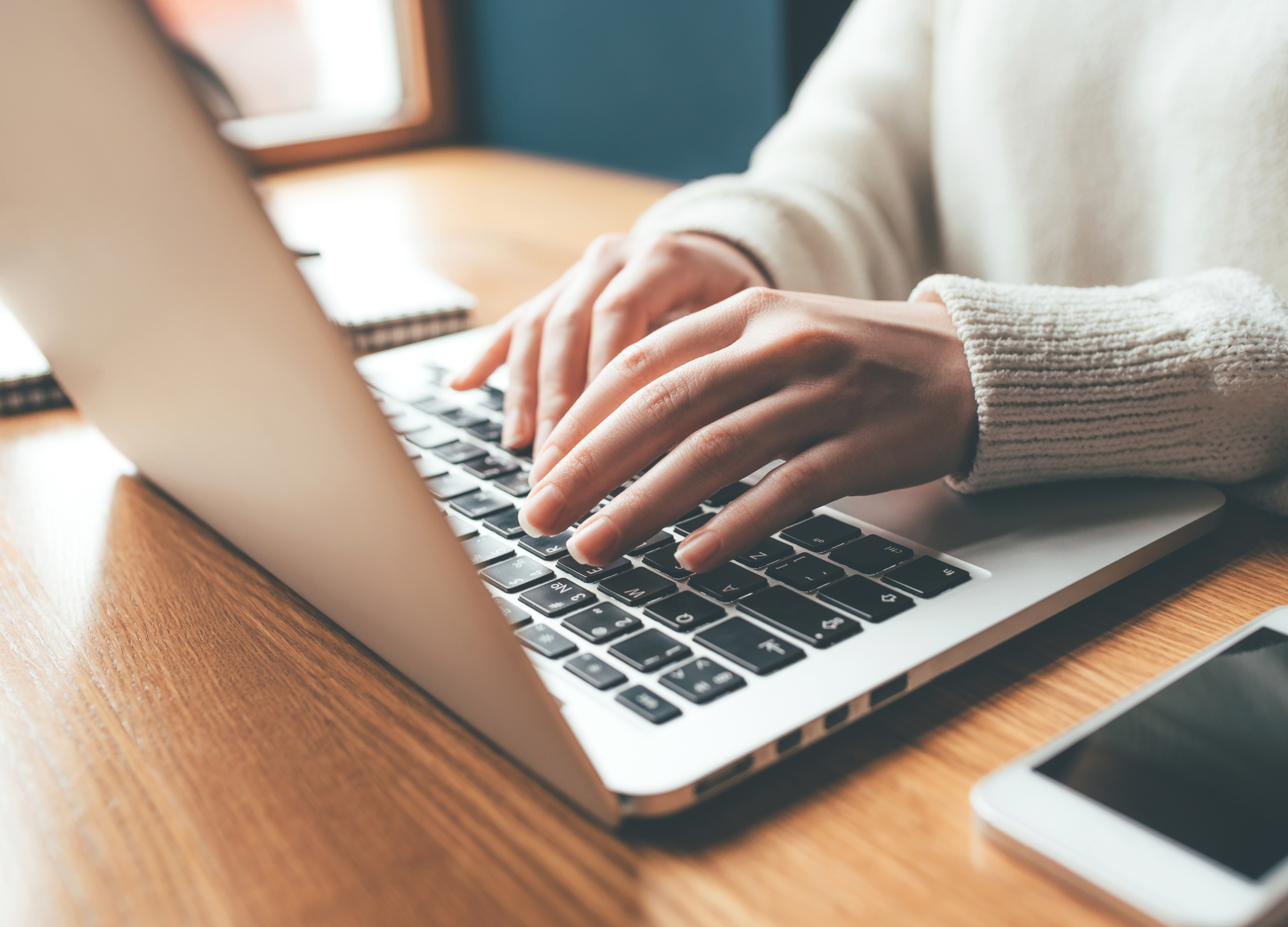 someone typing on a laptop