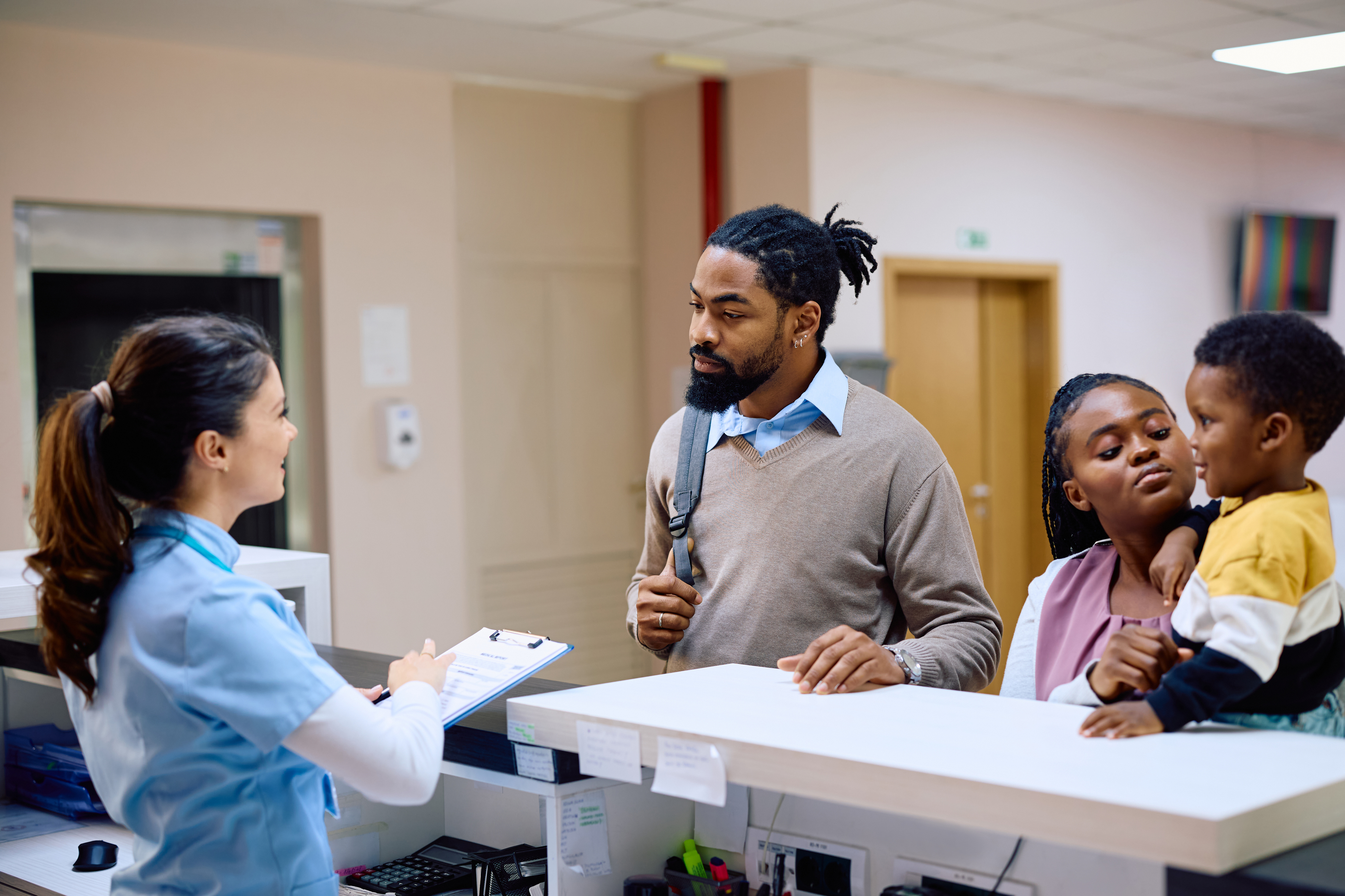 Medical Assistant Checking in a Family