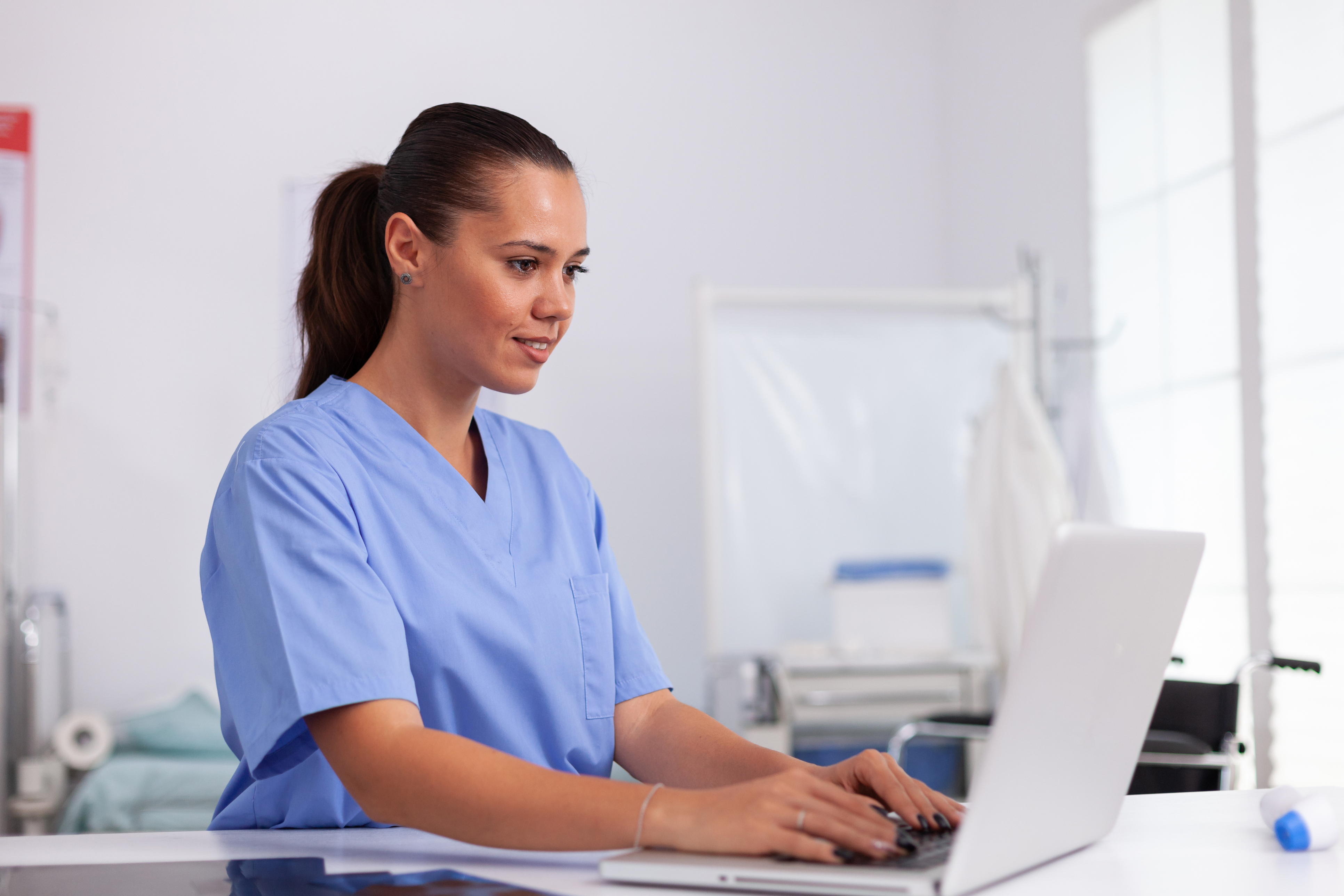 iStock-1906789885 Medical assistant at desk typing